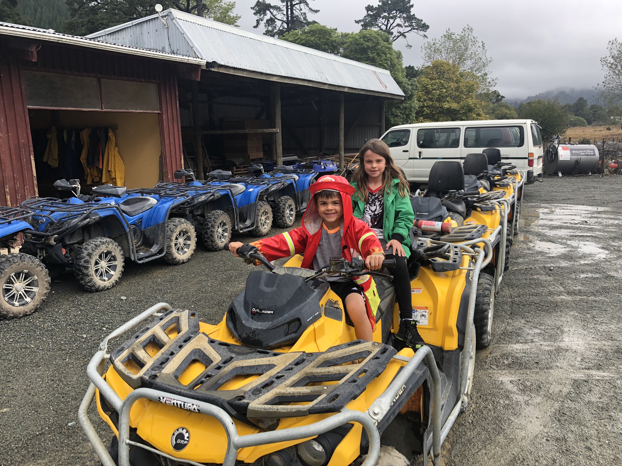 Children riding yellow ATV-style vehicles.
