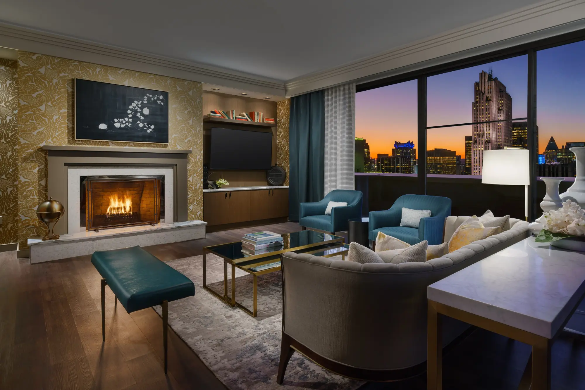 Contemporary decor fills a large common space with a fireplace and great skyline views