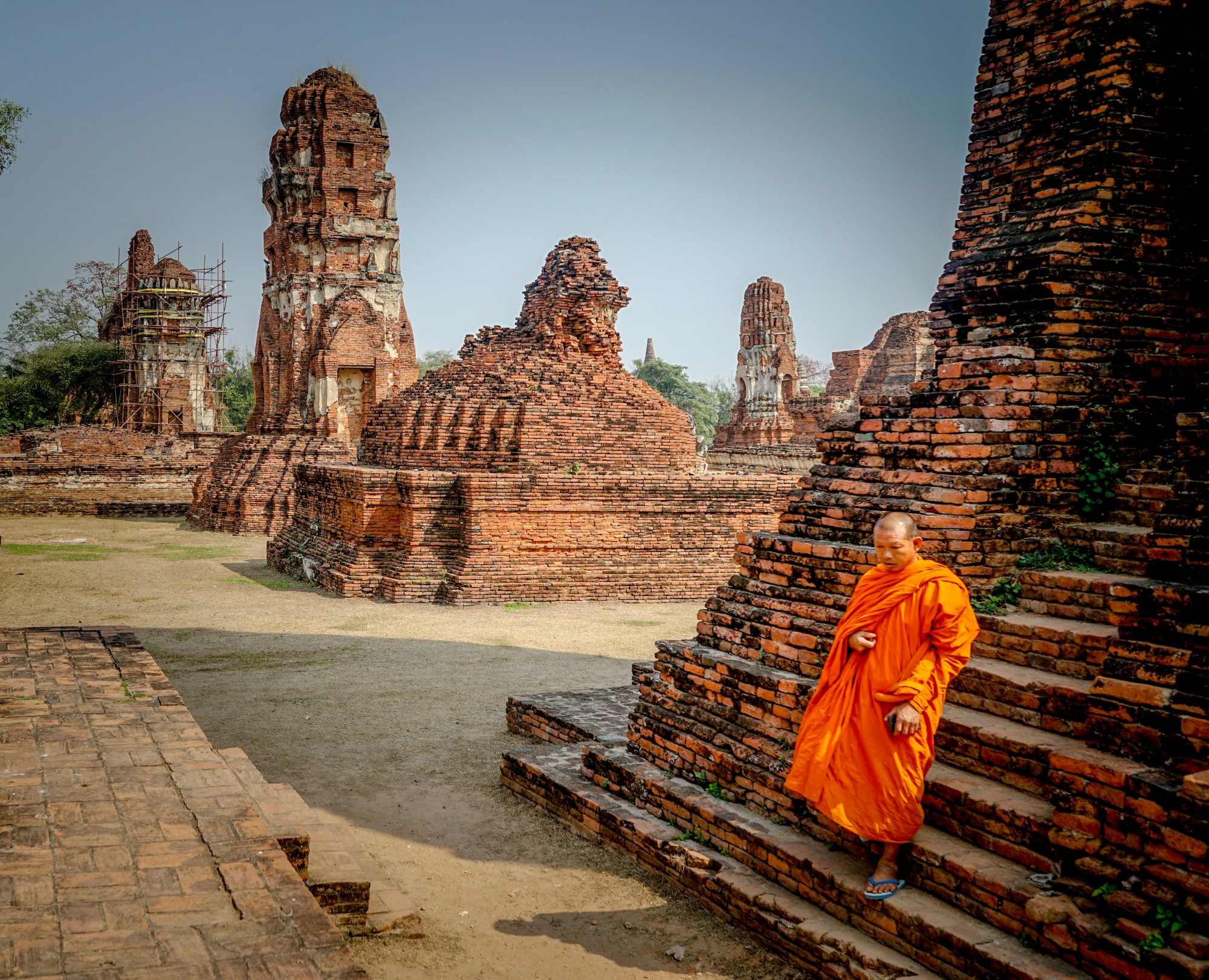 Temple ruins stand tall against a clear blue sky.