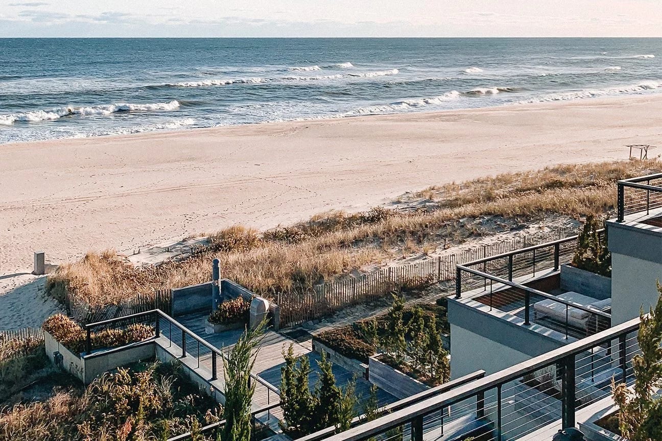Several rooms at Gurney's Montauk Resort & Seawater Spa have balconies with loungers, and a staircase leads directly to the beach, with small waves washing ashore