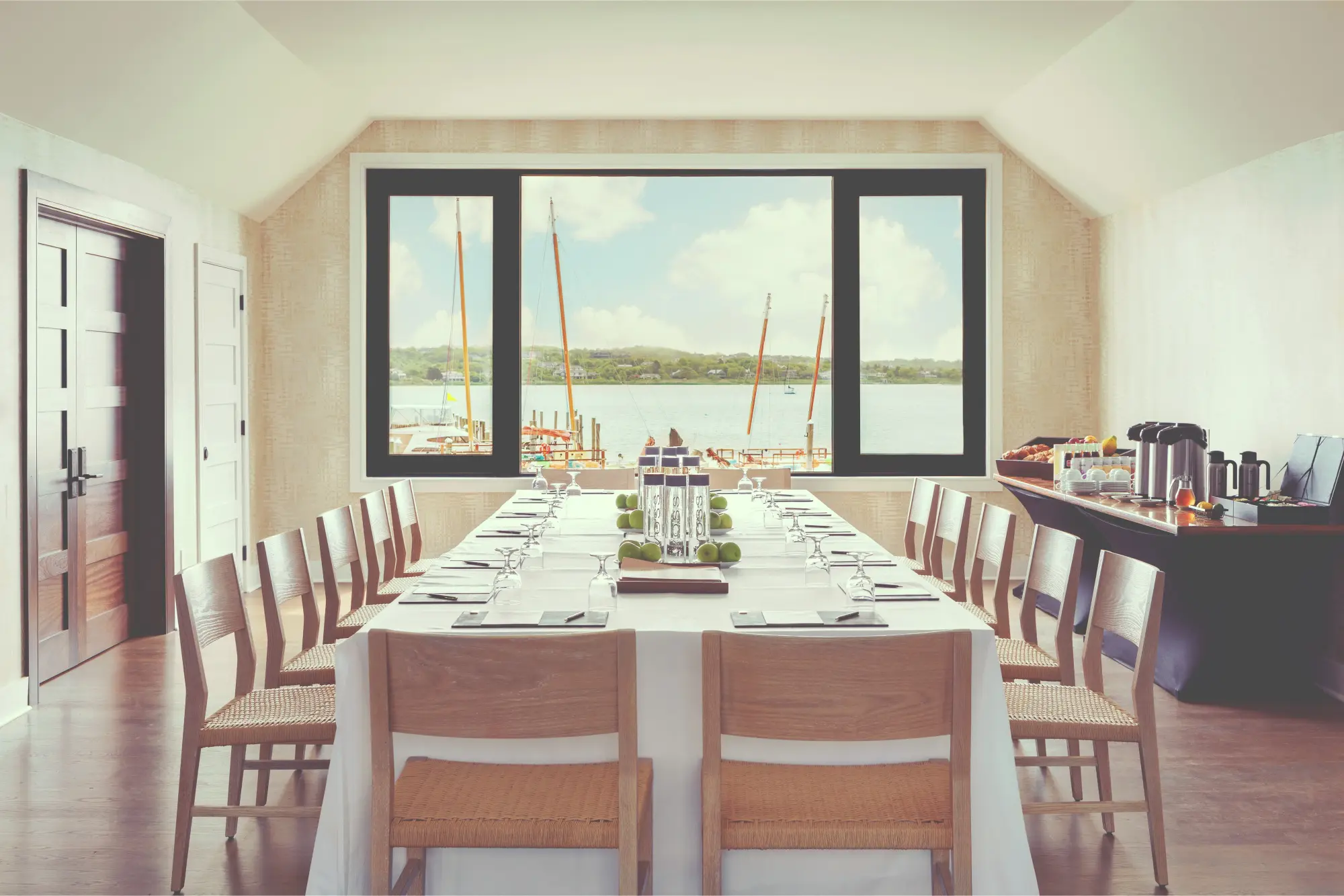 Elegant table setting with an adjacent breakfast bar and a wide window with a view of the Montauk marina