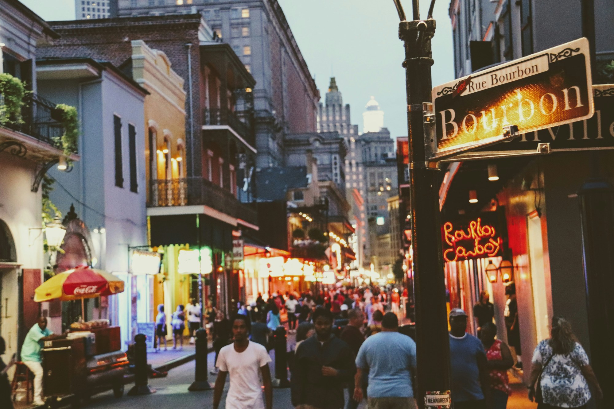 People walking down a city street in the evening