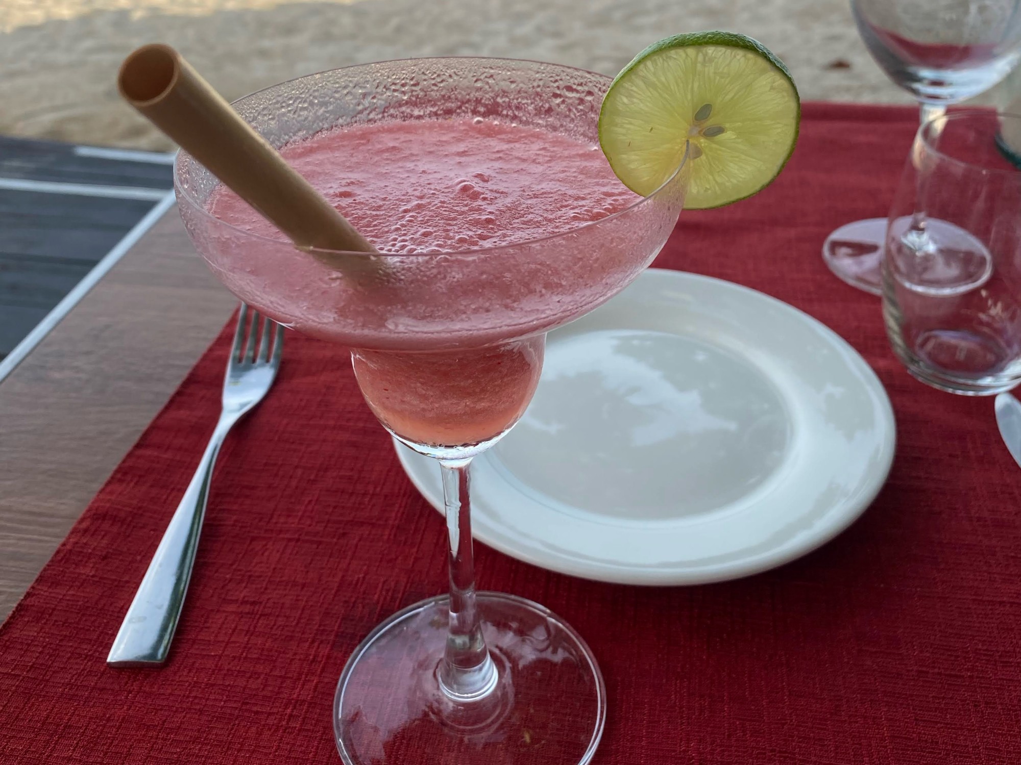 A pink cocktail on the beach.