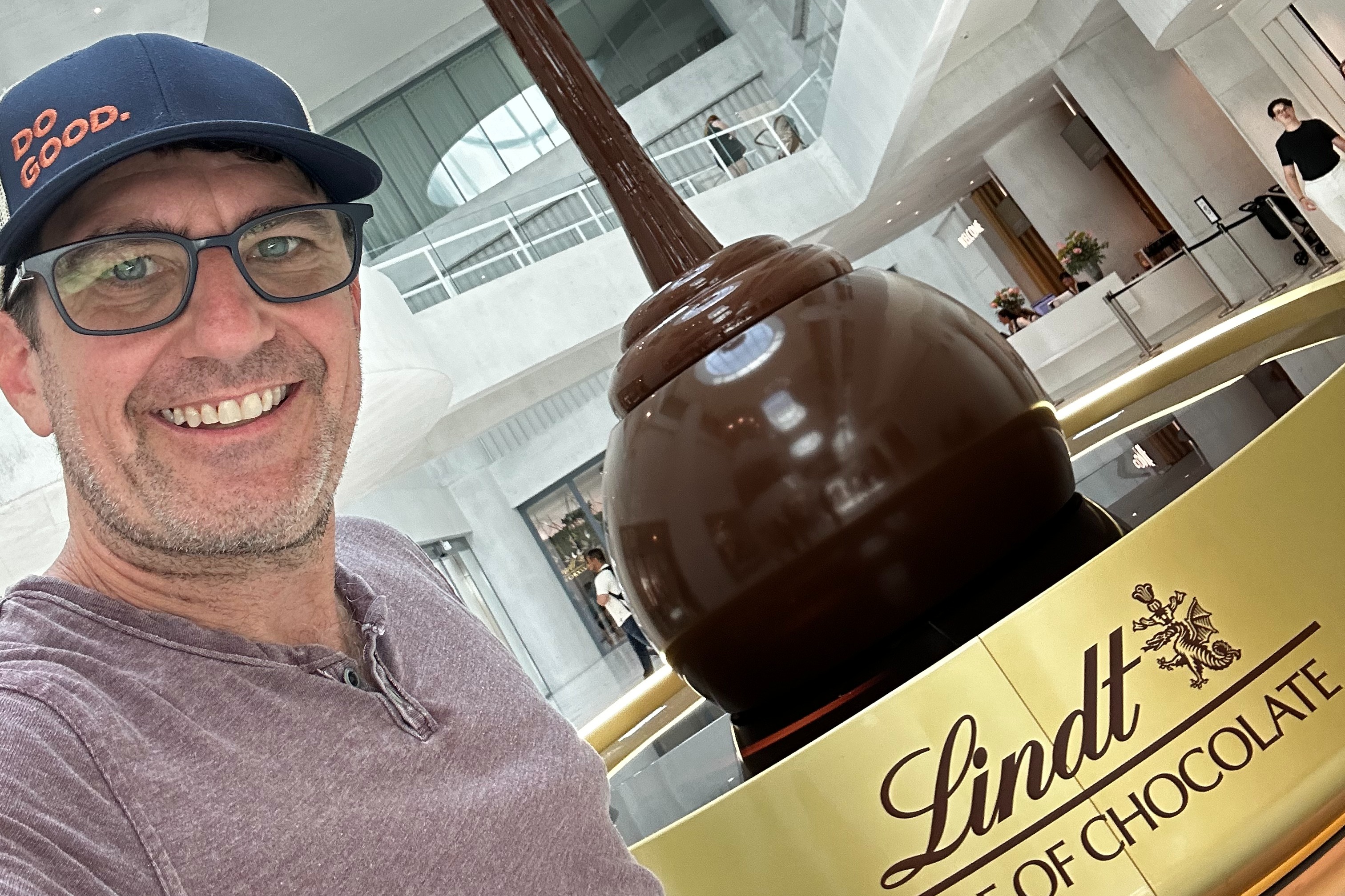 Advisor posing in front of a chocolate sculpture.