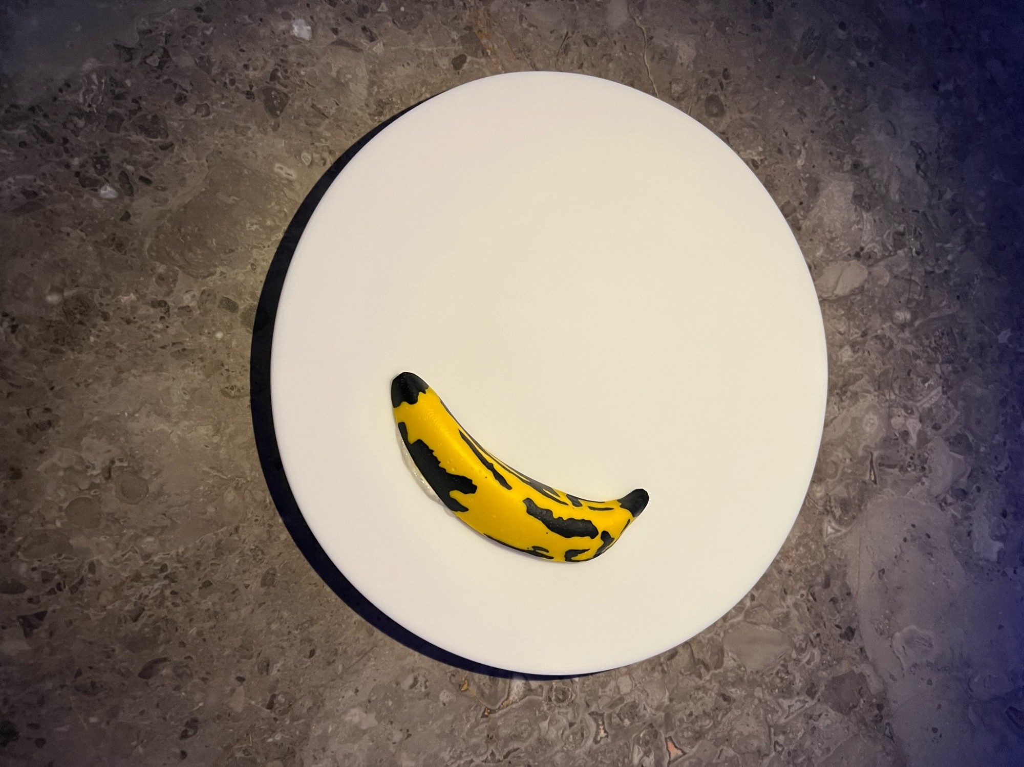 Banana on a white plate.
