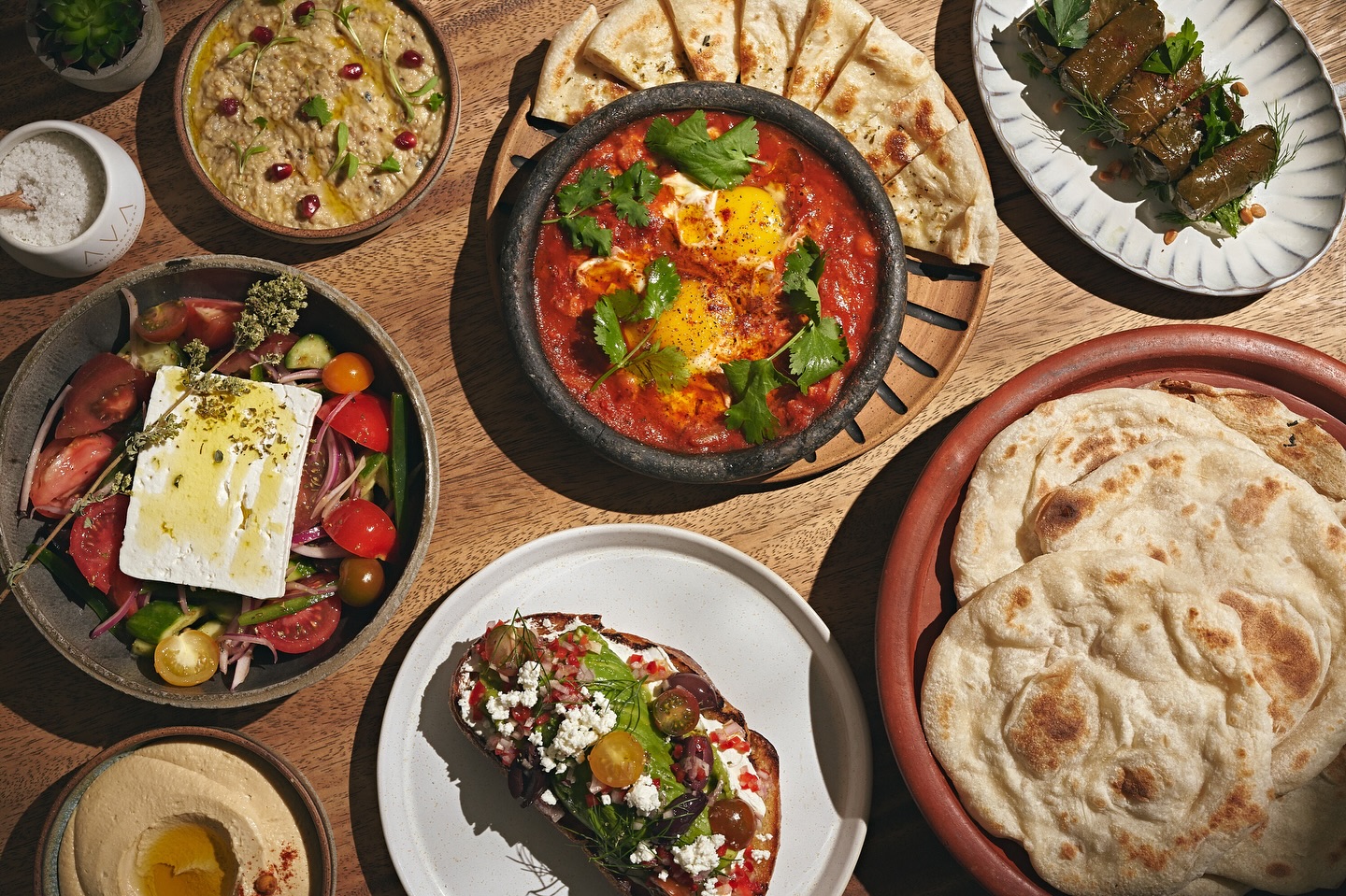 A table full of a selection of Mediterranean food.