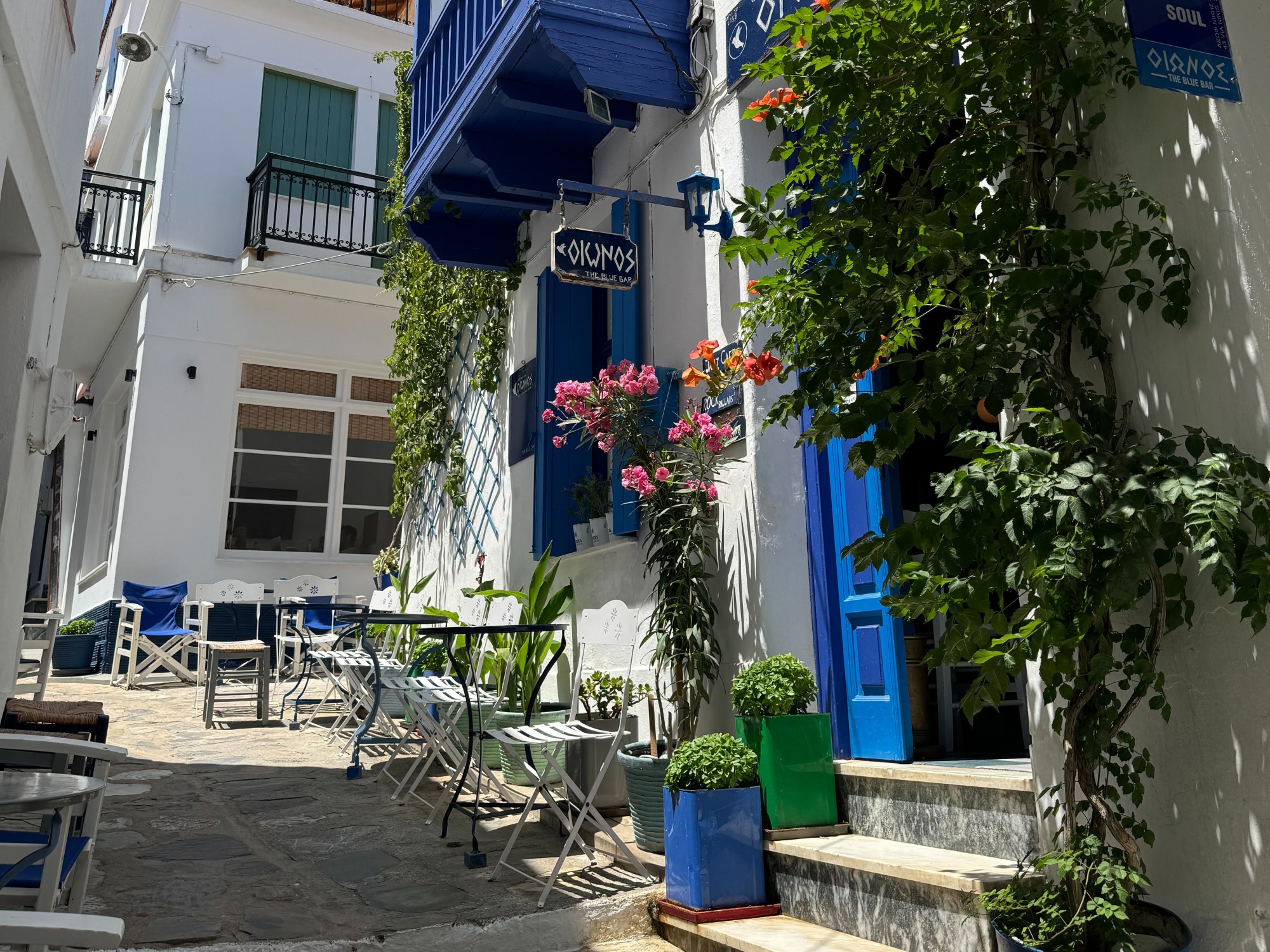 White and blue buildings on a street.