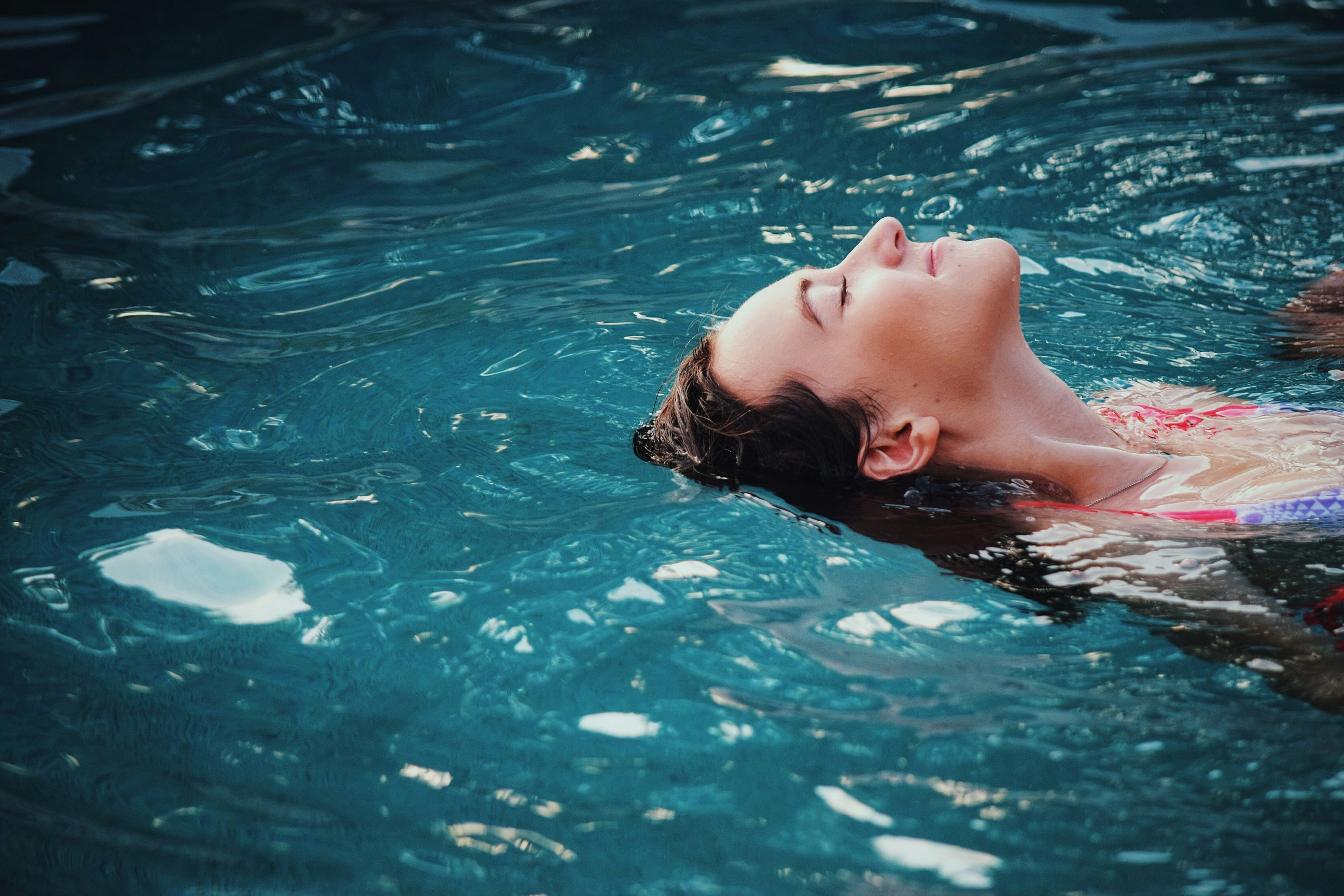Woman floating in a swimming pool