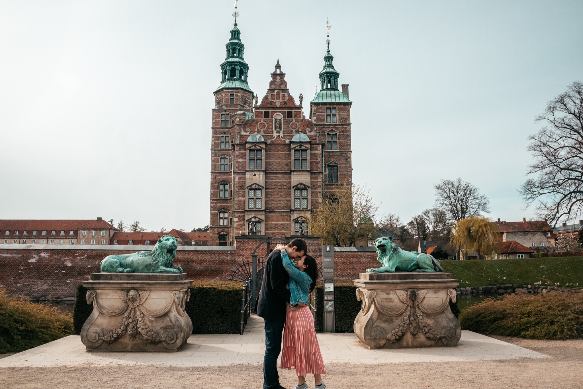 a man and a woman embrace each other in front of an old building