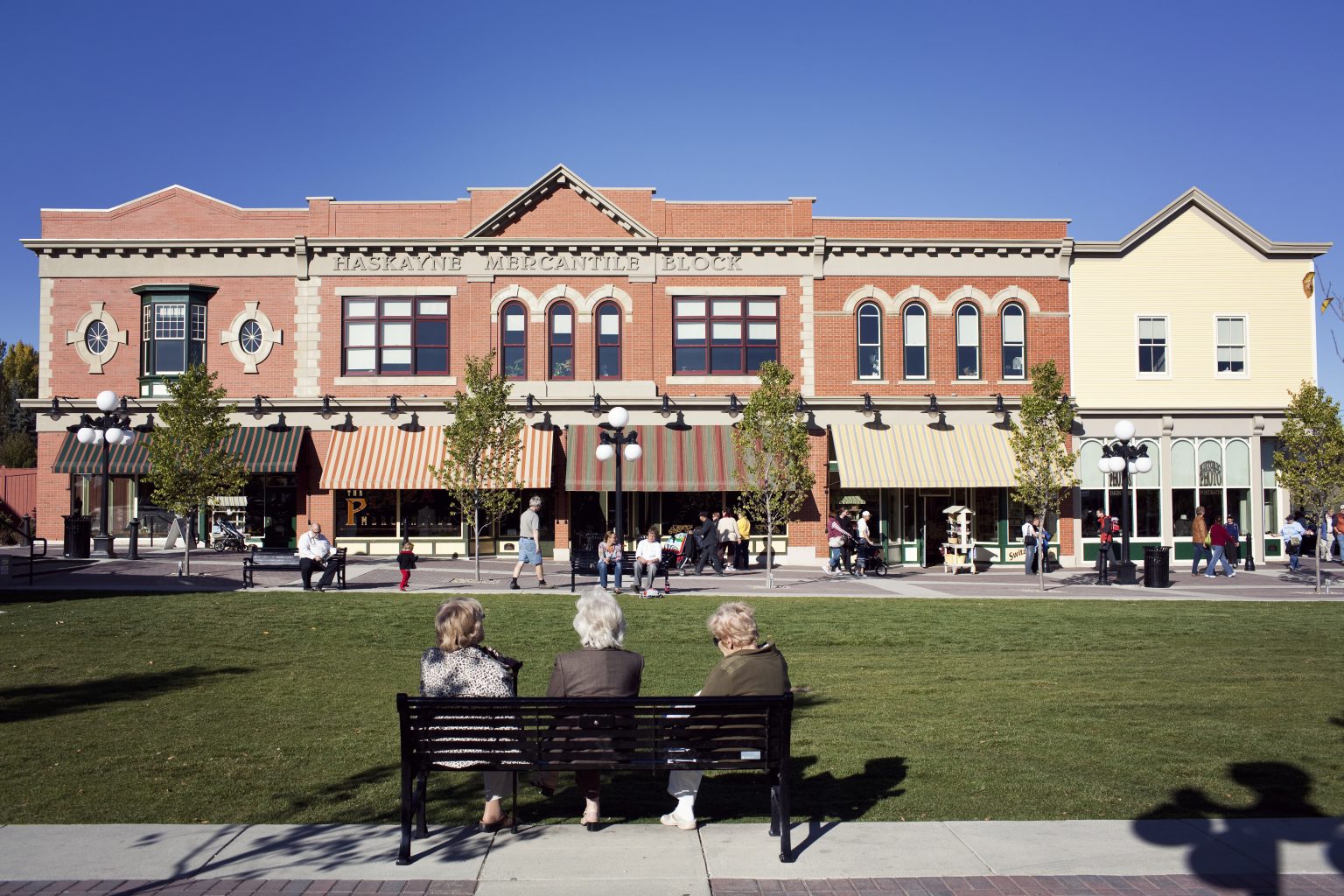 Heritage Park is a living history museum in Calgary stretching in front of a large park area on a sunny day.