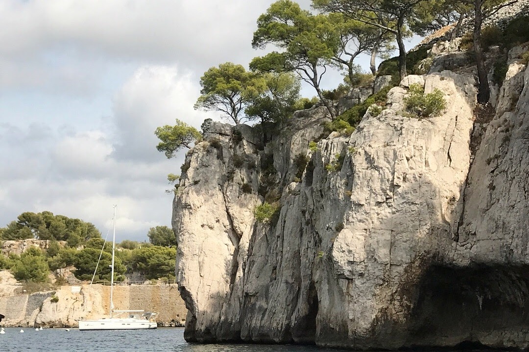 A rocky cliffside next to a body of water