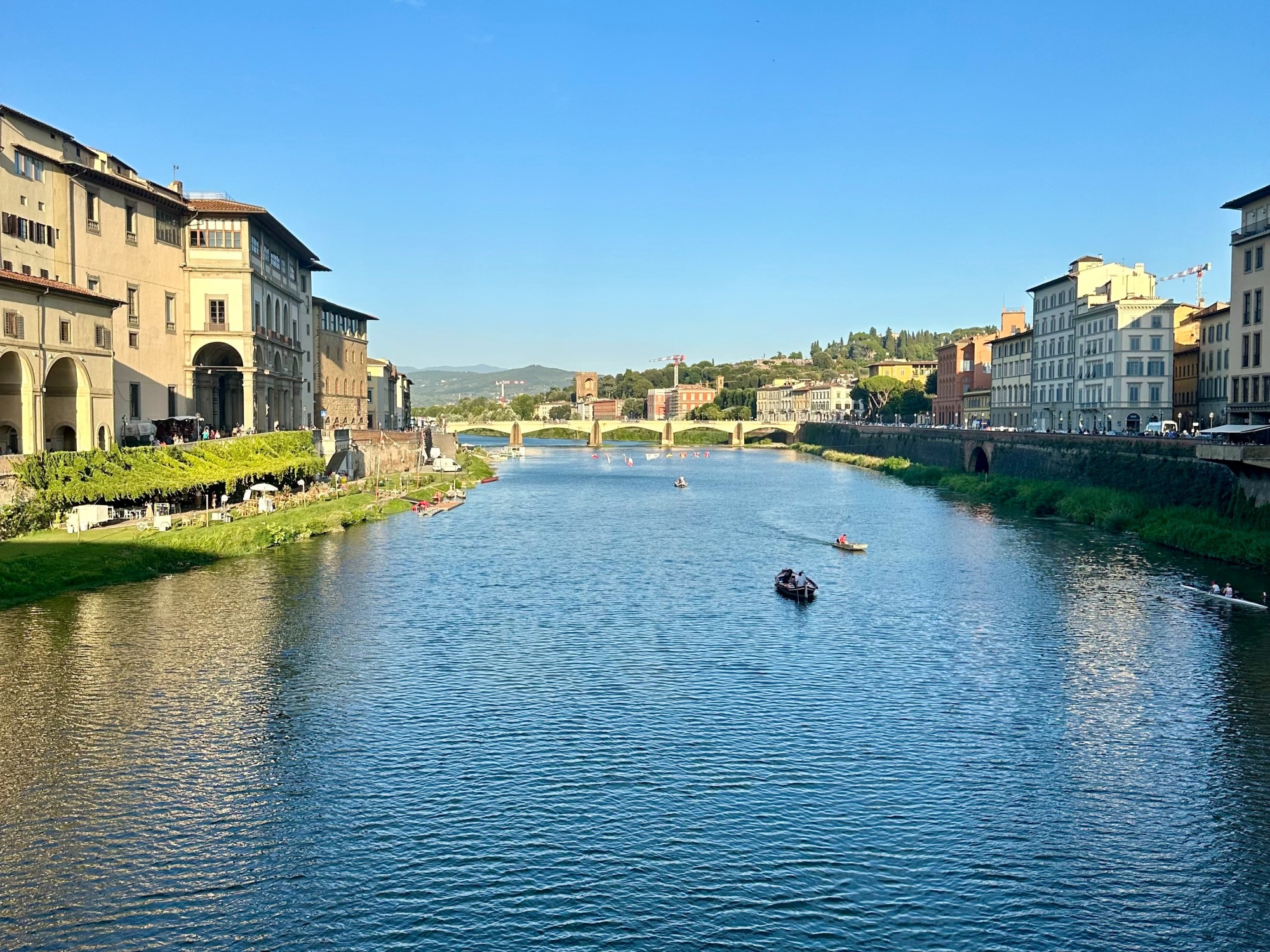 Boats on river flowing in city.