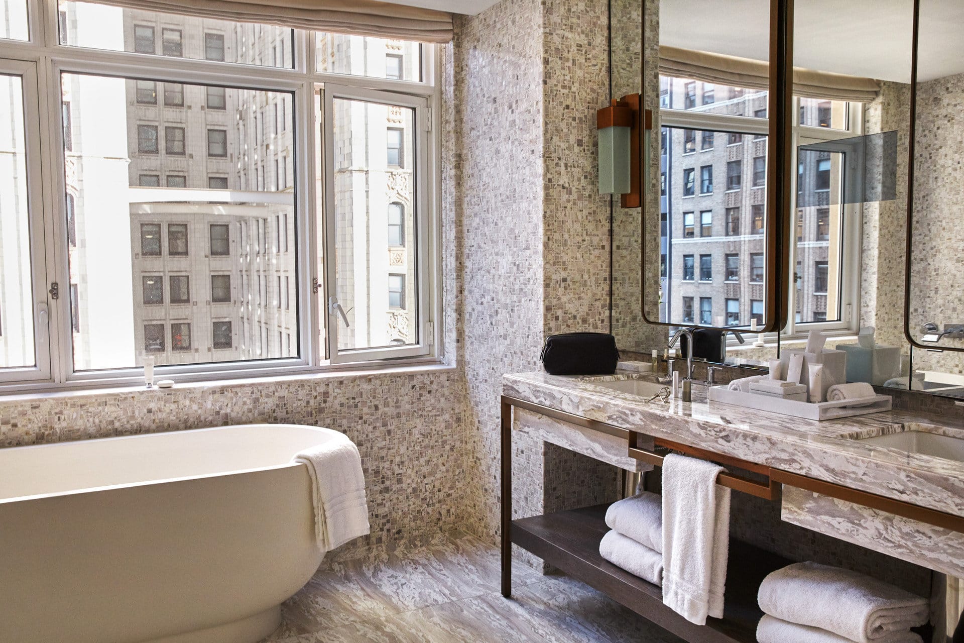 Marble bathroom with a soaking tub, expansive sink and great views