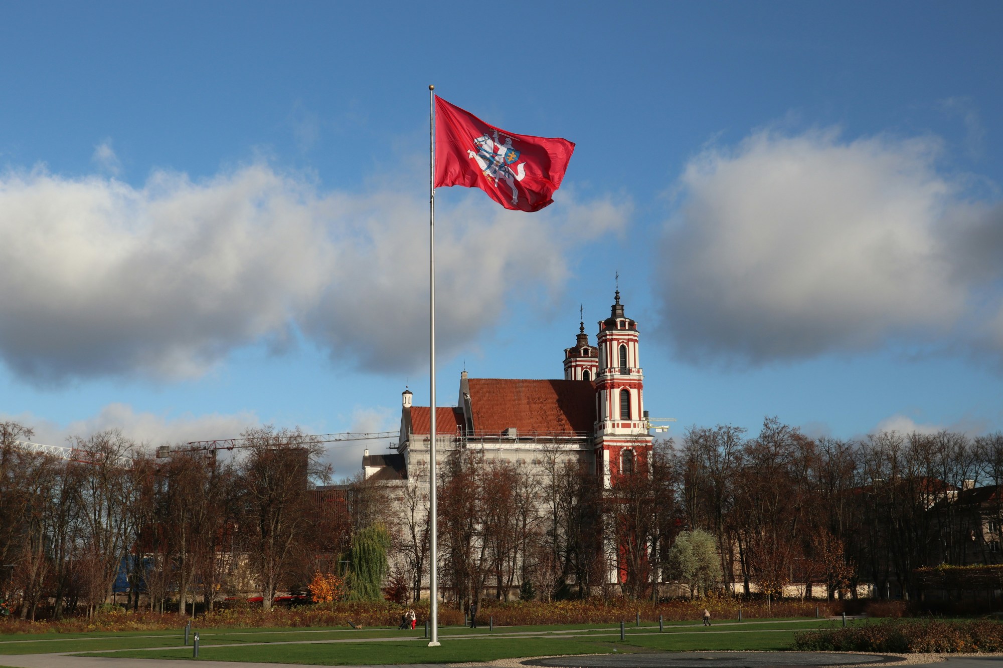 Red flag in front of a large building.