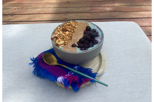 One of the delectable bowls offered at the Balance Hotel cafe artfully arranged with a bright spoon and napkin.