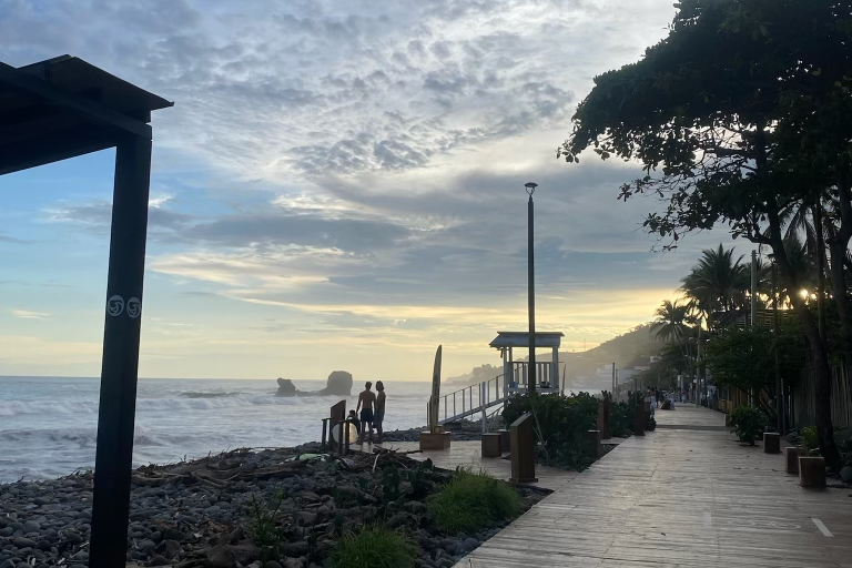 This pathway is lined with restaurants, bars, and cafes, with the iconic El Tunco rock (for which the town is named after) in the ocean in the background at dusk.