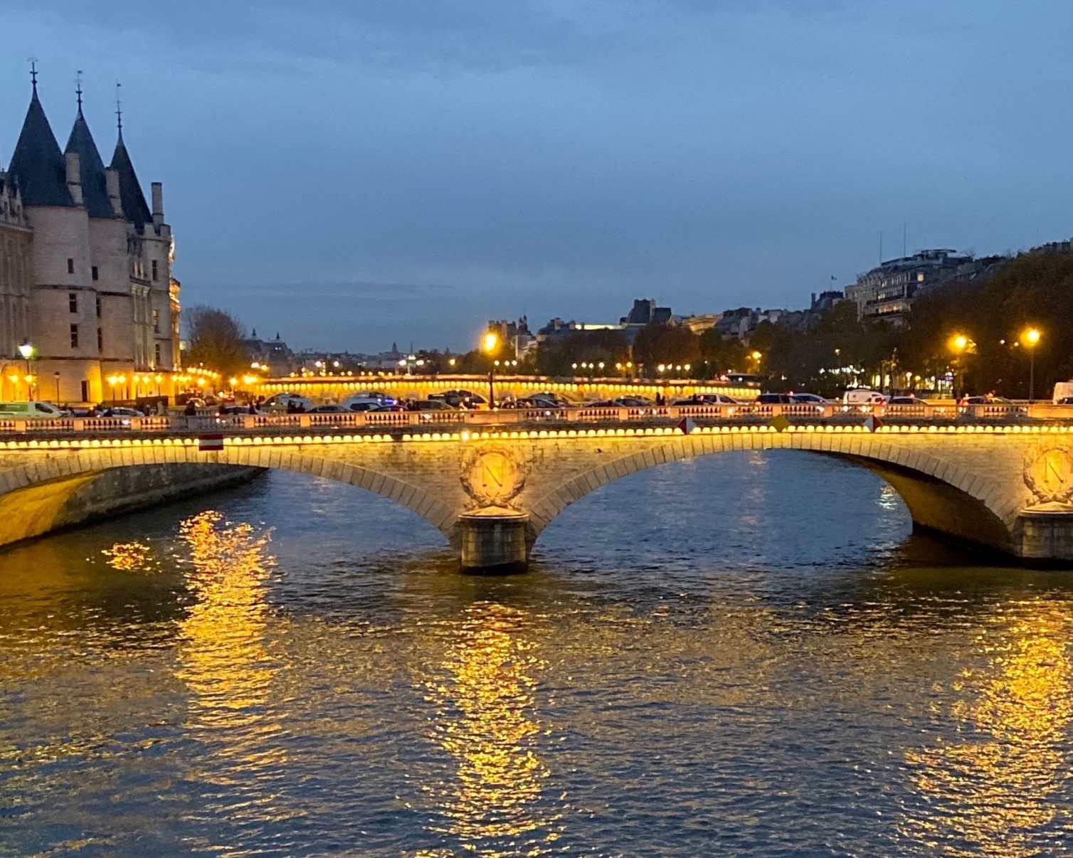 A well lit bridge over a river.