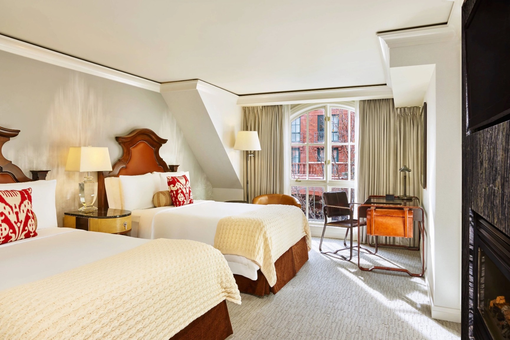 bedroom with two queen beds and a view of a brick building