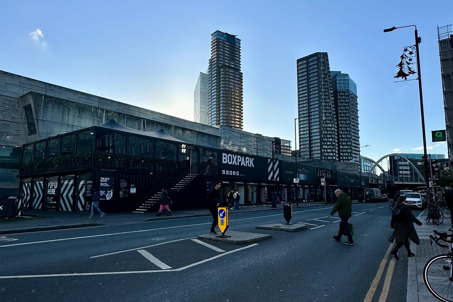 A street outside of an event space with view of two skyscraper buildings