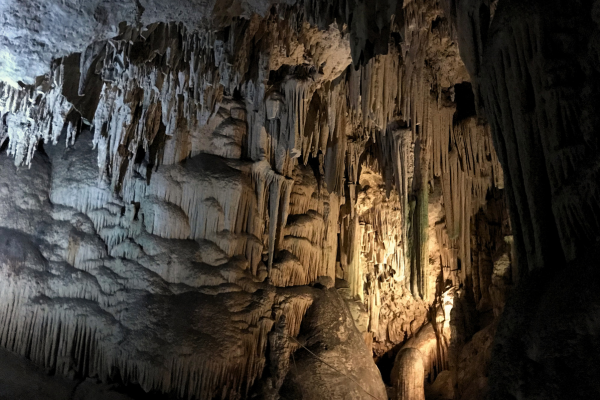 A photo inside dark caves with dripping rock formations in Cueva De Nerja, a tourist spot in Nerja.
