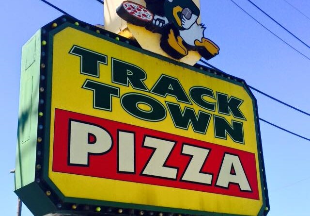 Yellow and red signage for Track Town Pizza.