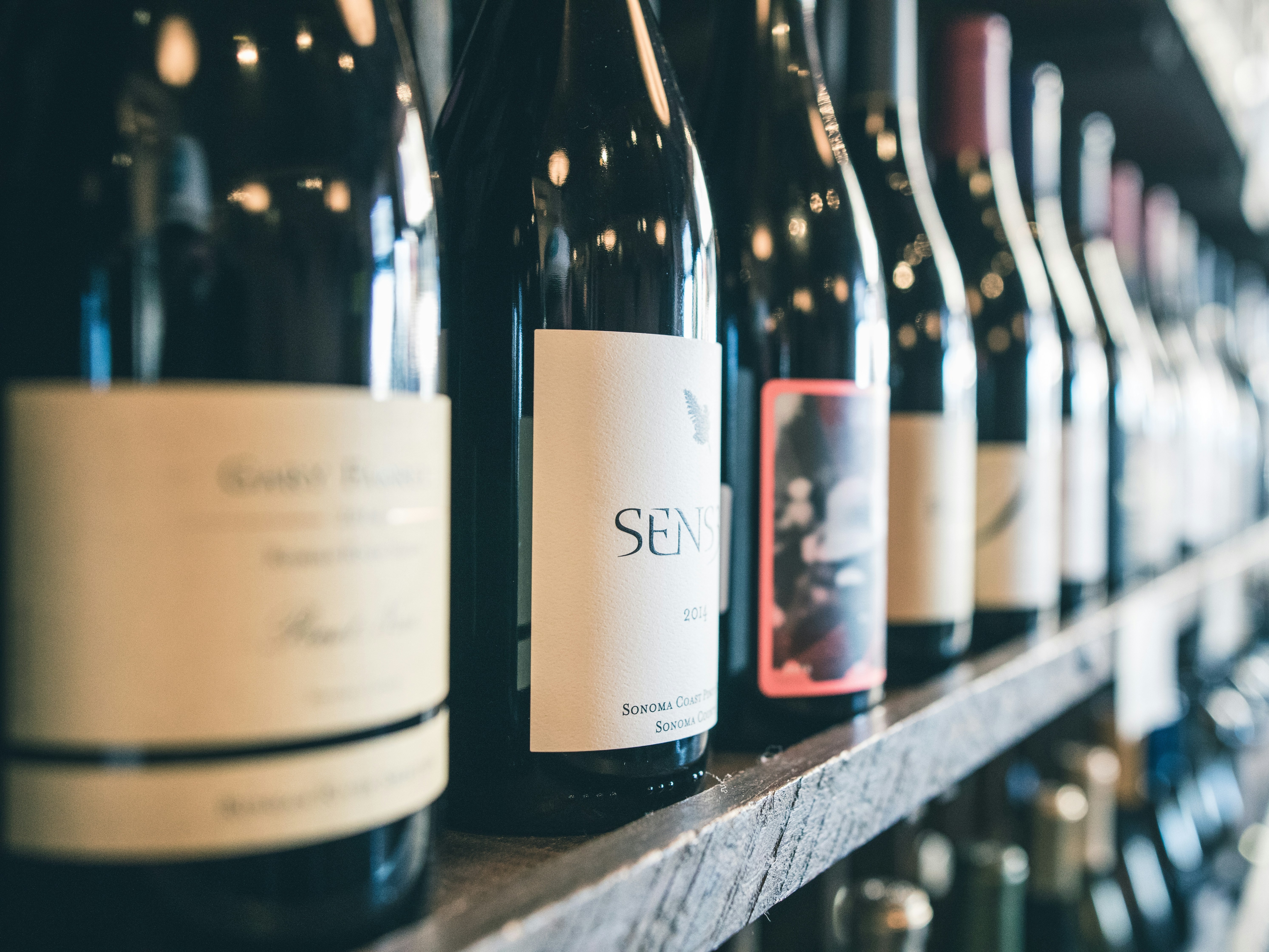 The image displays a curated selection of wine bottles.