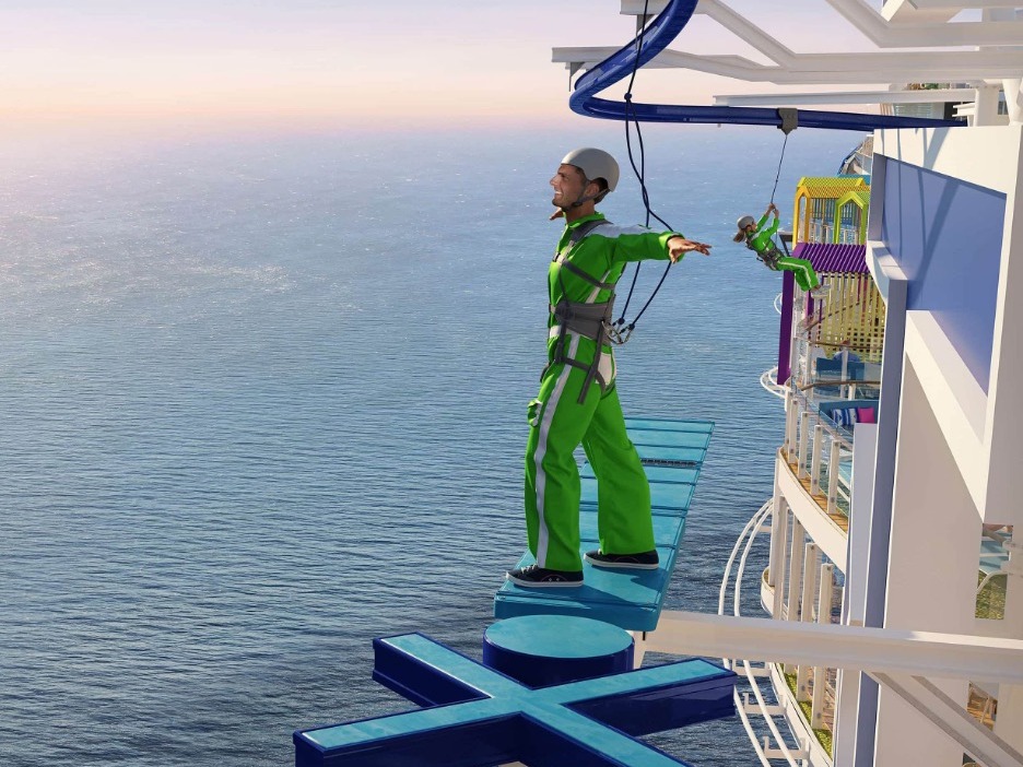 A green-clad person walking on a ledge, high above the ocean’s expanse.