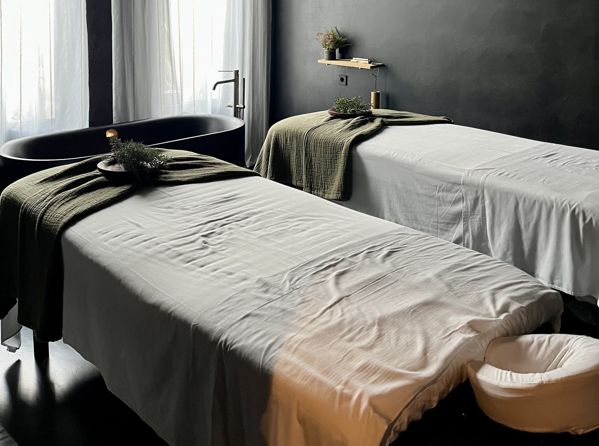 Spa room with two cots made up for massages and relaxing treatments.