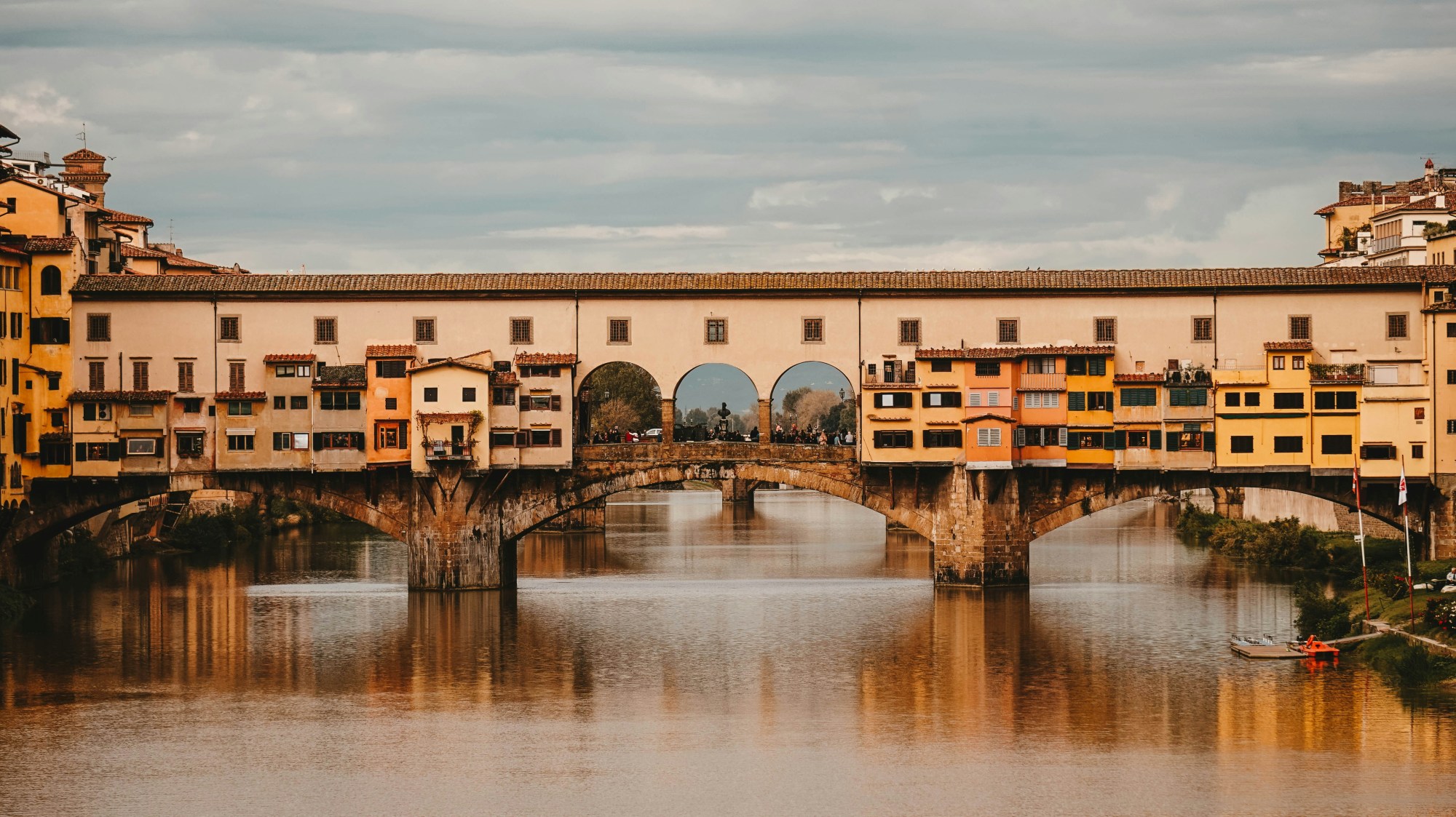 Bridge with buildings on water.