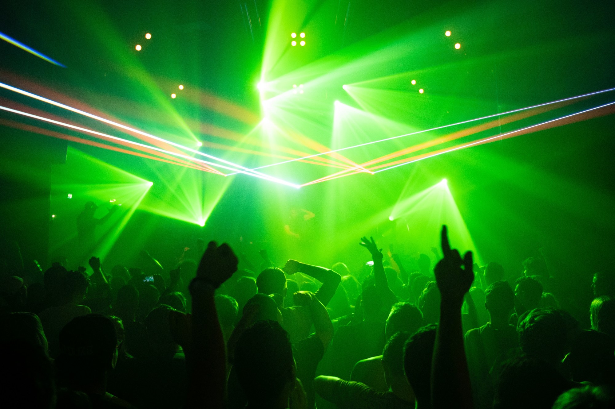 People in a club with green lights.