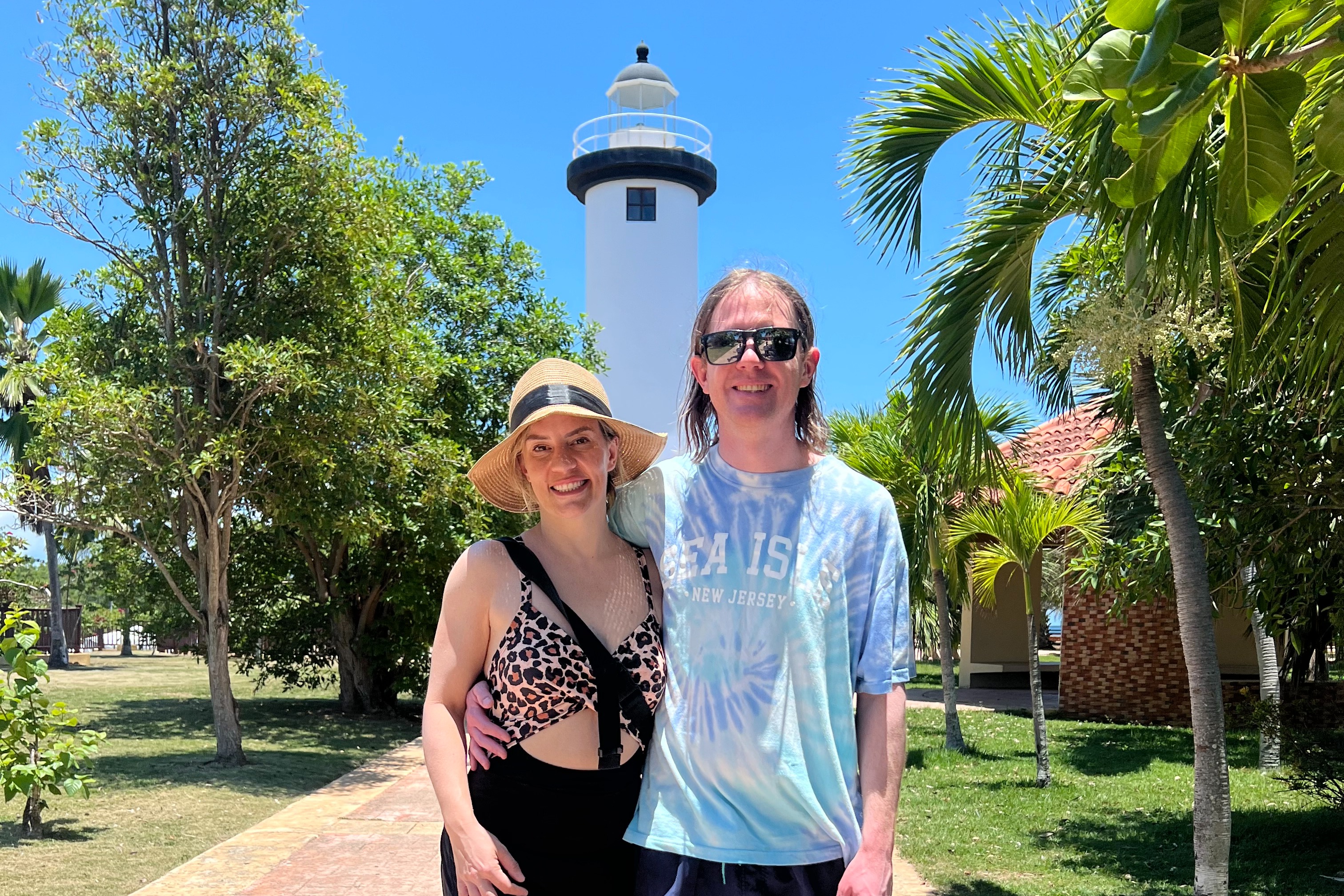 A couple standing behind the Rincon lighthouse.