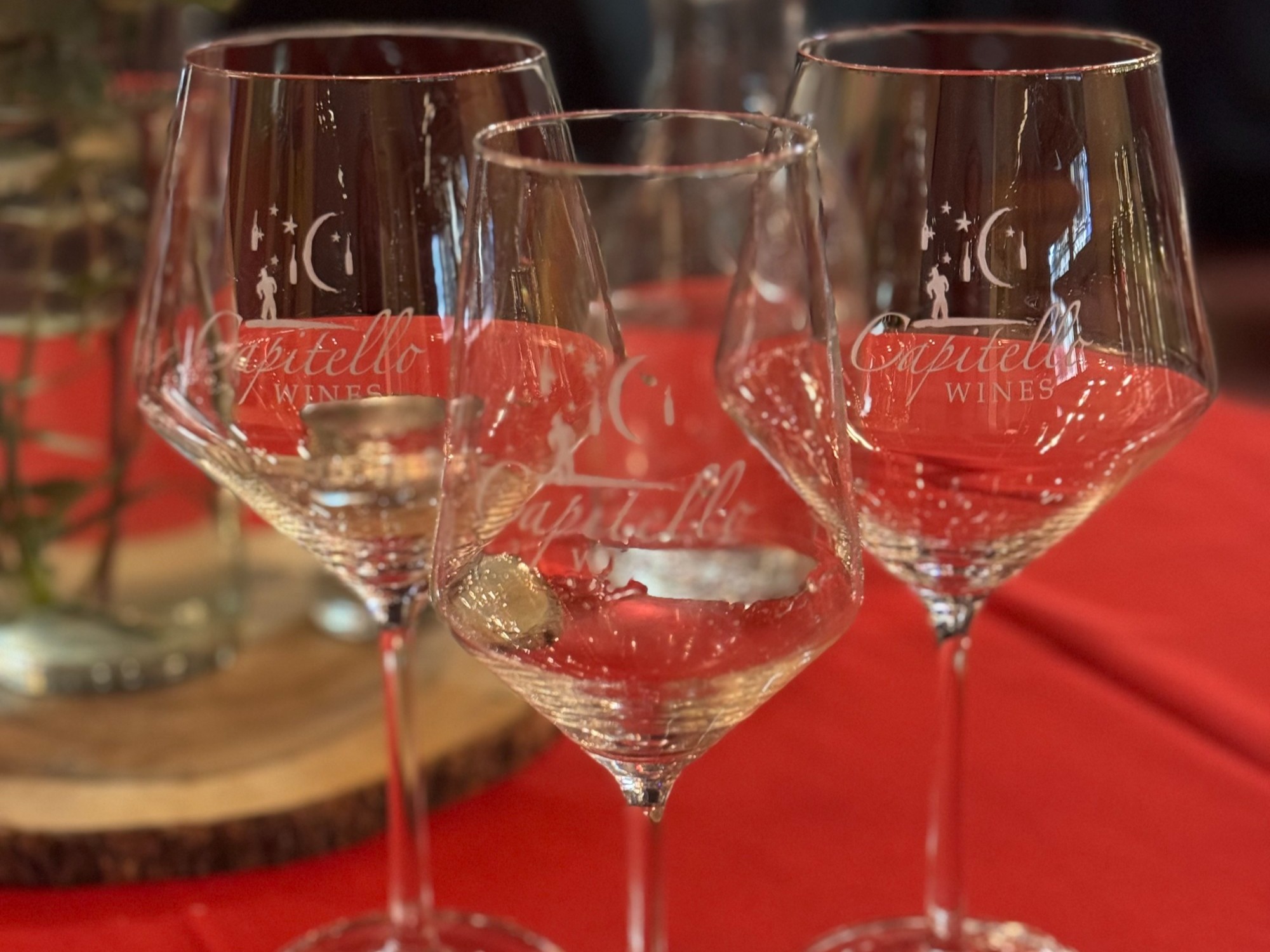 Three wine glasses on a table.