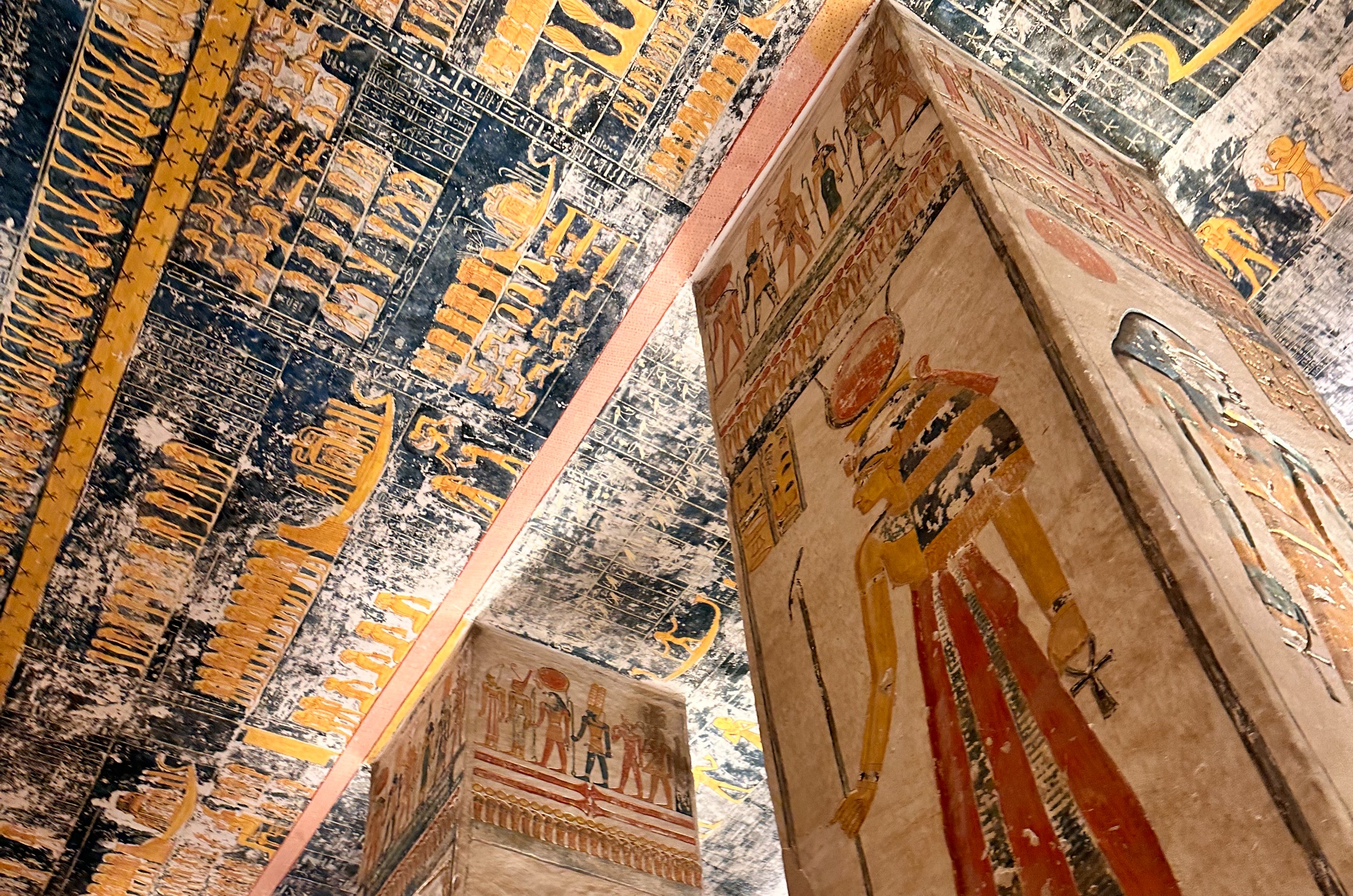 The image showcases vibrant ancient Egyptian hieroglyphics and artwork within a tomb or temple, reflecting a rich cultural legacy.