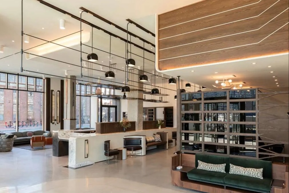 lobby with modern hanging lights, a white polished floor and contemporary seating areas