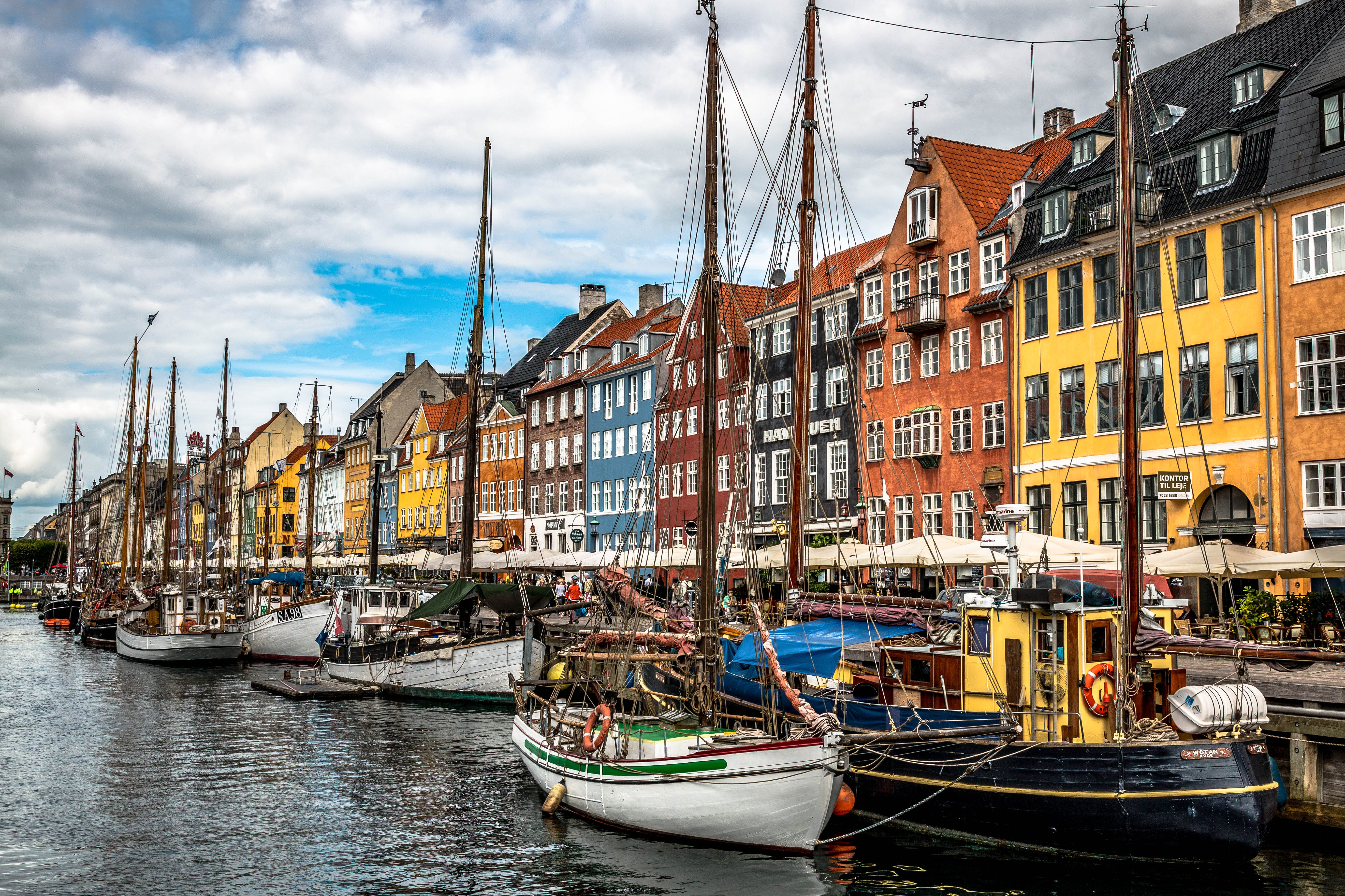 Nyhavn is a picturesque 17th-century waterfront known for its vibrant colored houses, historic wooden ships, and lively atmosphere.