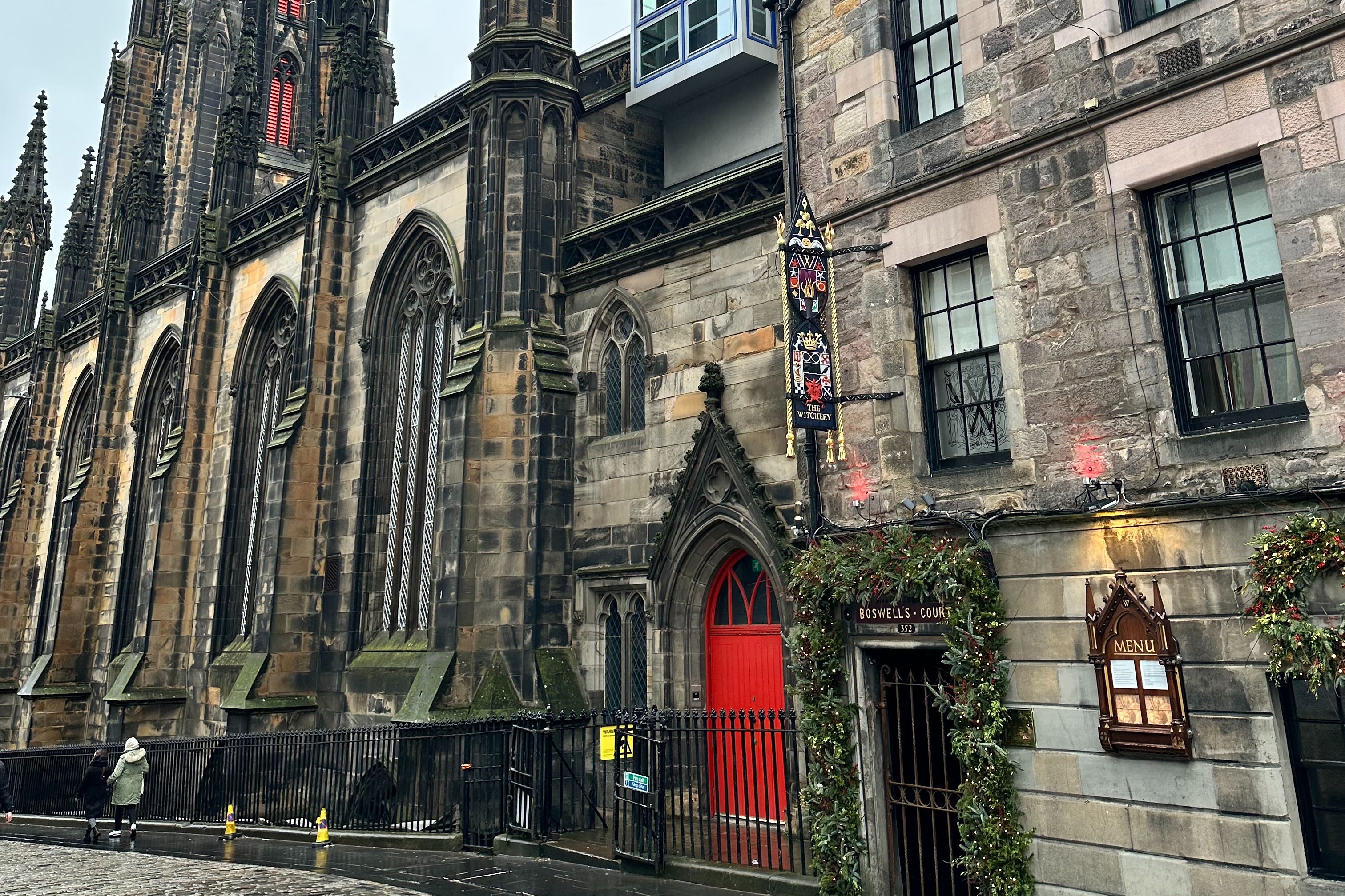 The Gothic exterior of the Witchery by the Castle, with a red door.