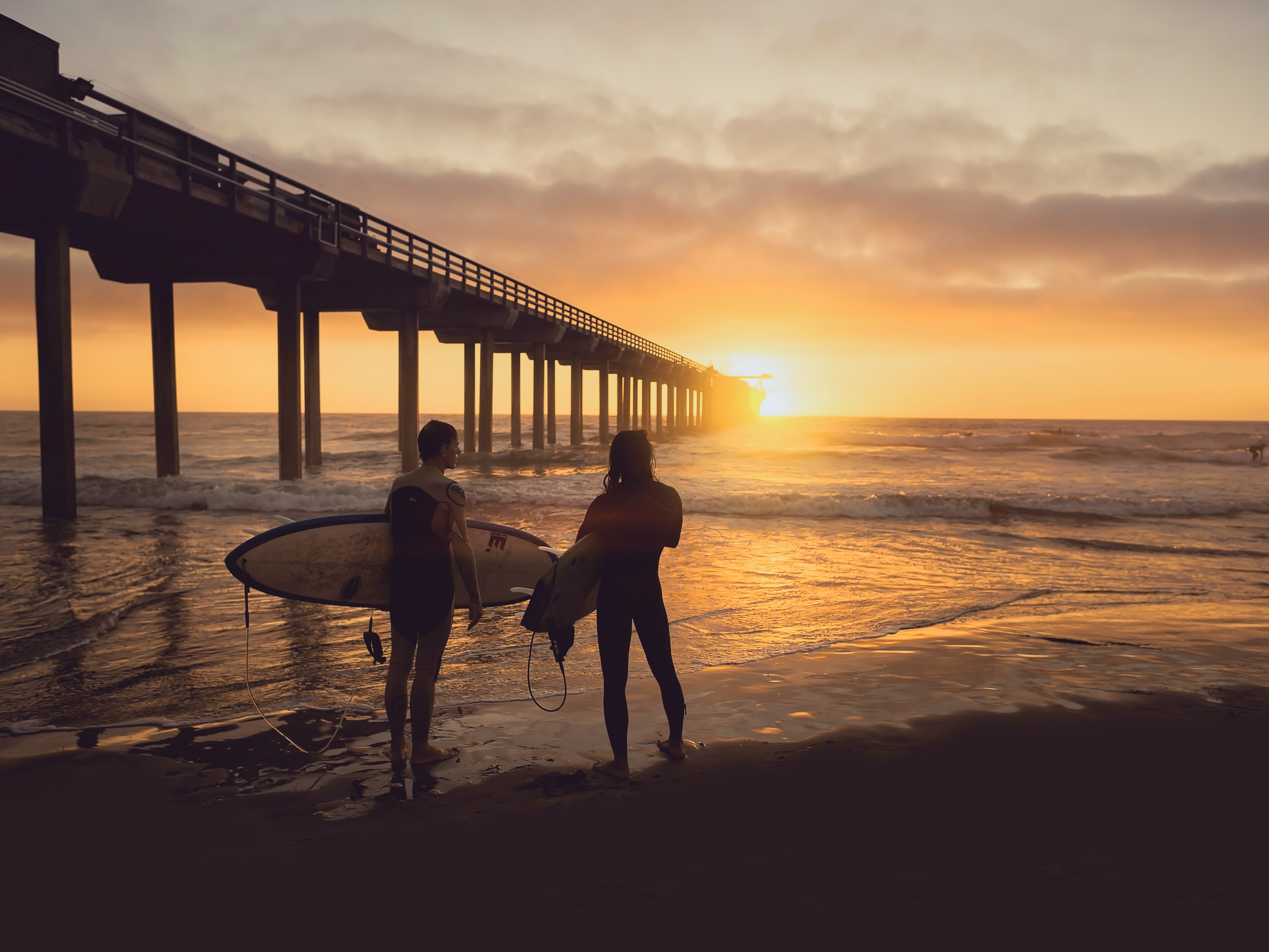 woman-carrying-surfboard-beside-person-costa-rica-travel-guide