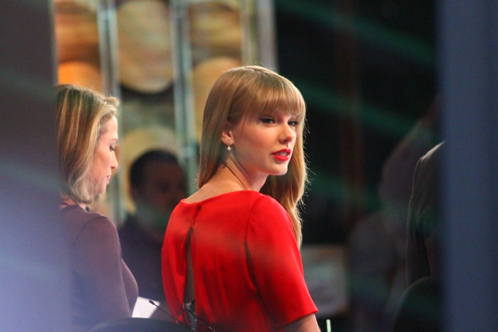 Taylor Swift in a red top wearing bright red lipstick; original image can be found at https://www.flickr.com/photos/paolov/8114091892