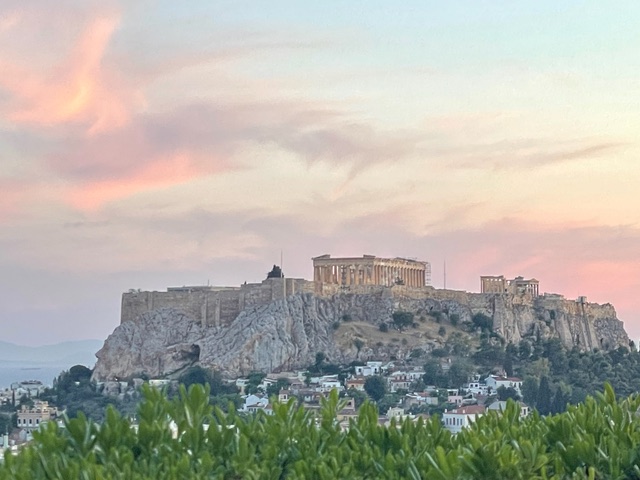 The Acropolis on a rocky hill at sunset.