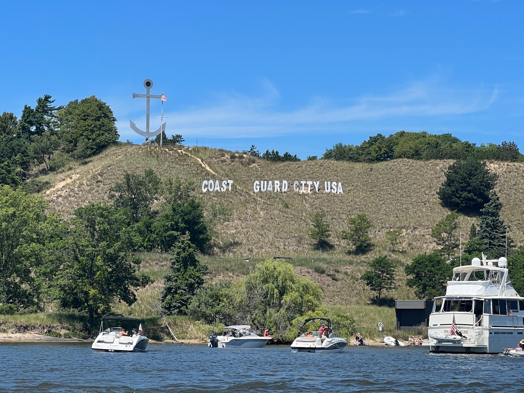 CGCUSA signage on a hilltop mountain range with foliage on a sunny day.