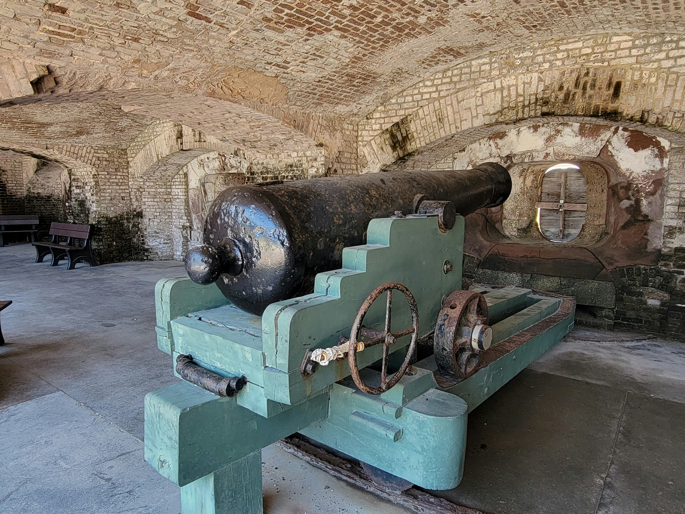 A large cannon in a brick building at Fort Sumter.