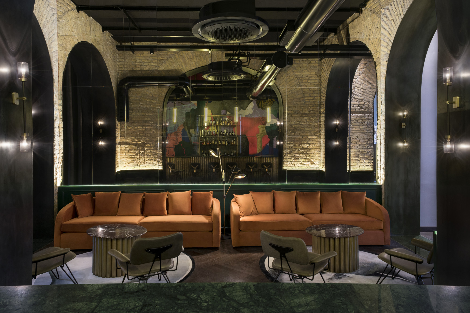 two orange couches in a dimly lit lounge