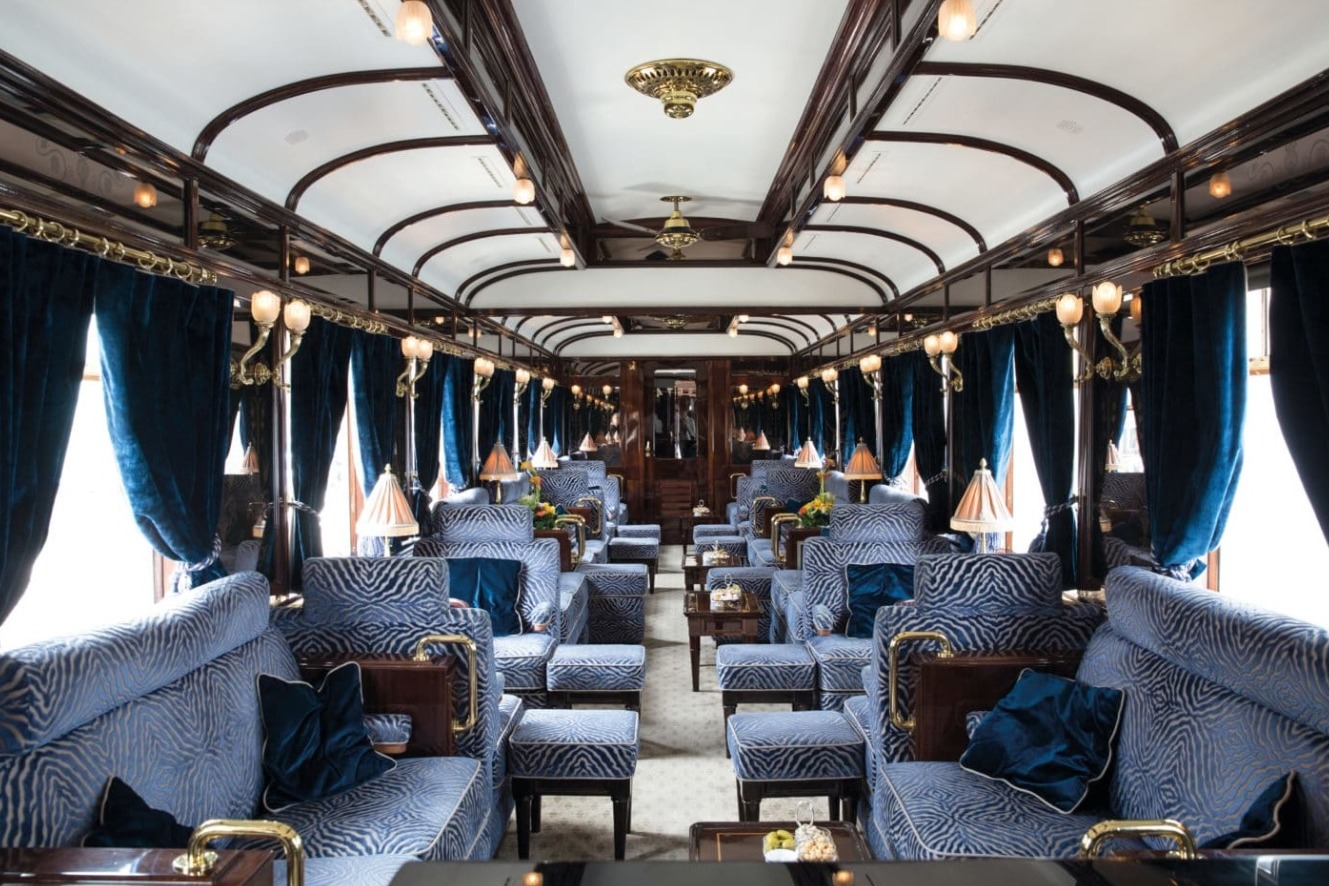 interior of a luxury train with blue and white upholstered seating