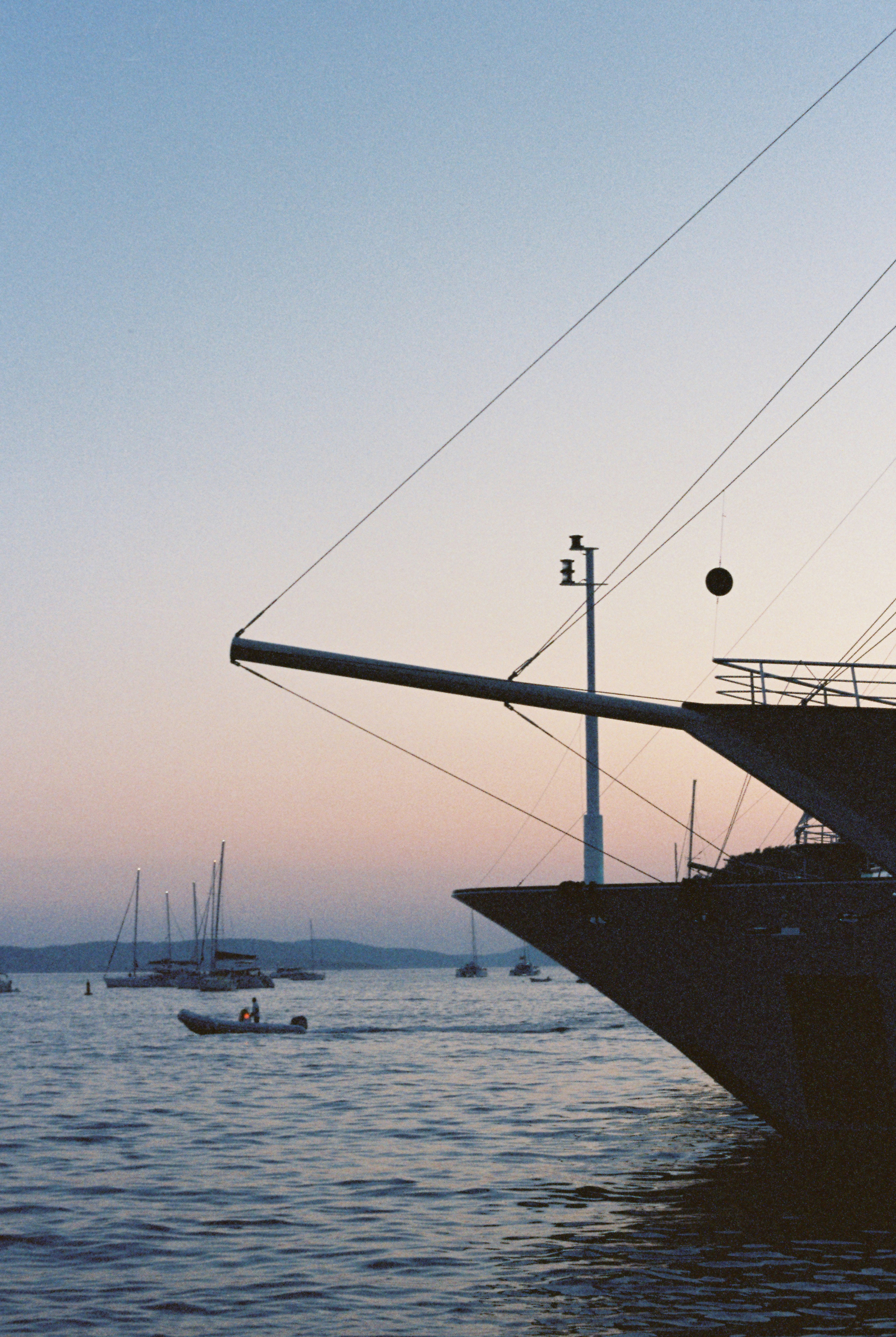 A view of a ship's bow, silhouetted against the sunset in Hvar, Croatia.