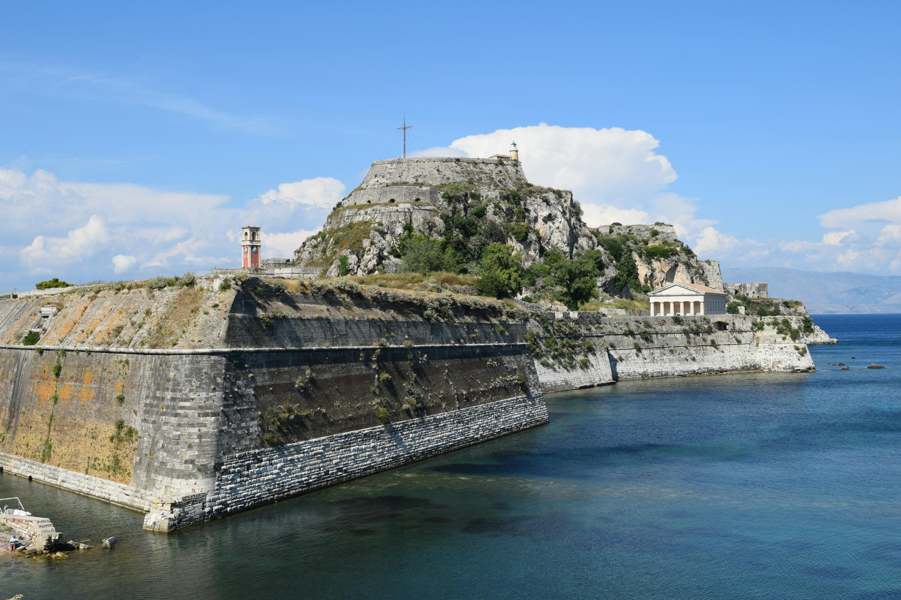 The Old Fortress of Corfu is a Venetia Fortress on top of a hill floating in the middle of the water.