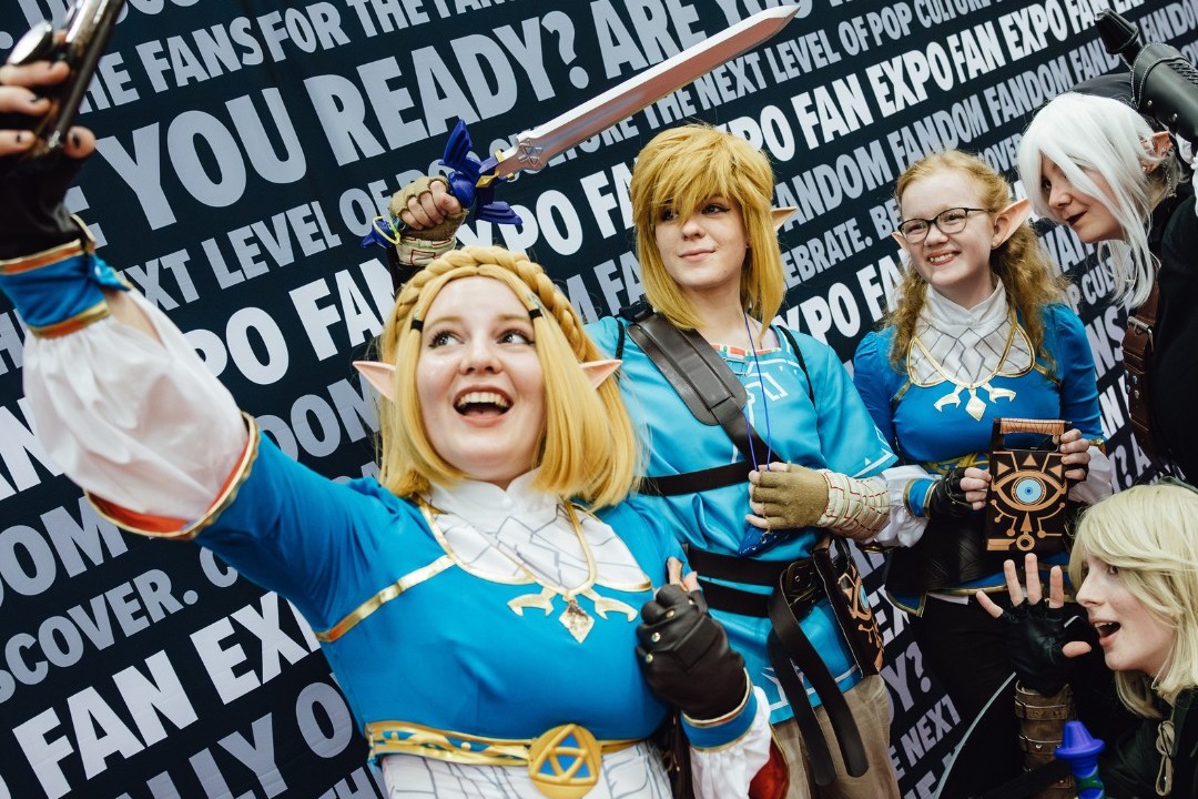 A group of people dressed up as characters posing for a selfie photo