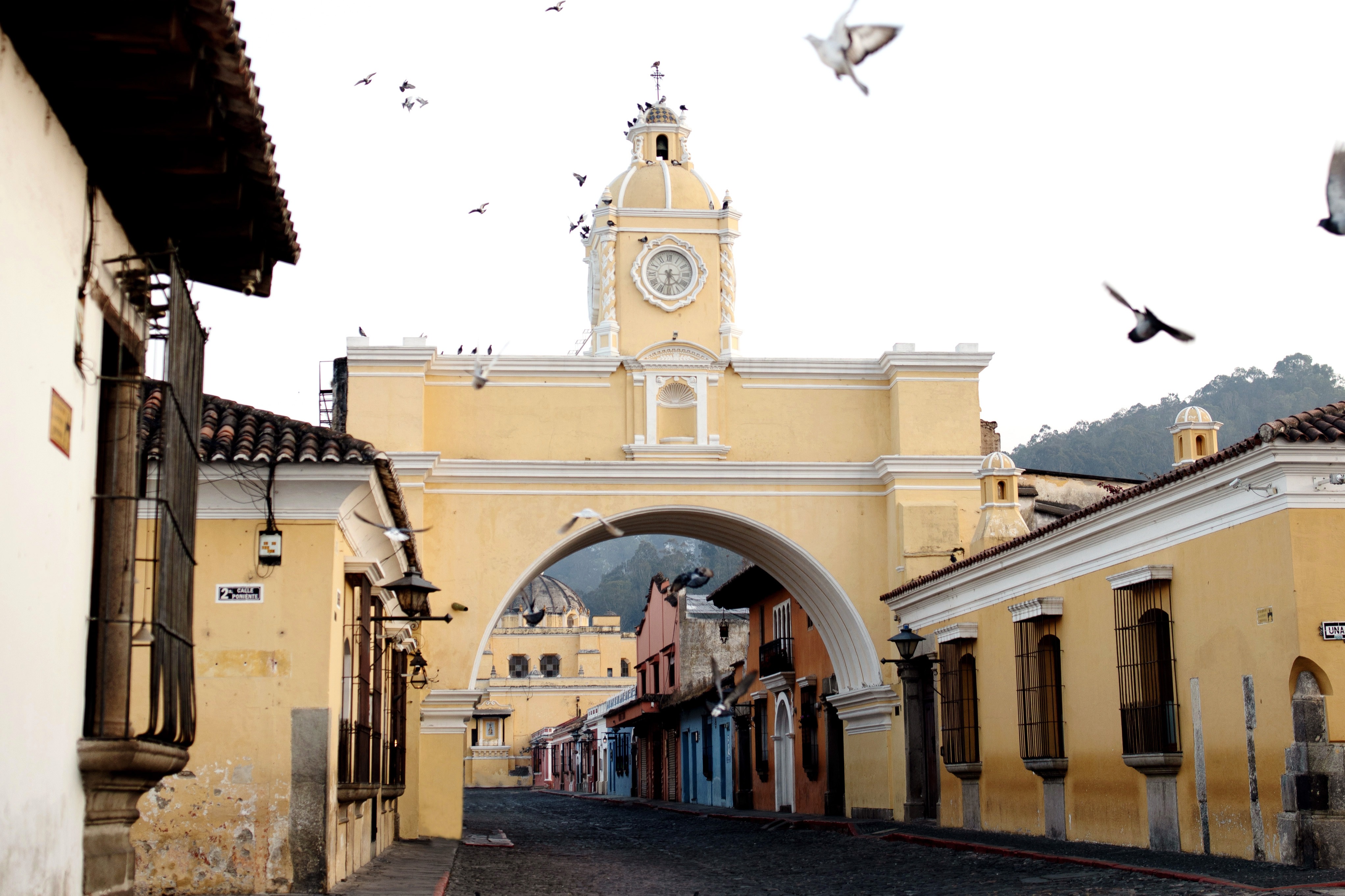 The Arco de Santa Catalina is known for its iconic yellow facade and scenic backdrop of the Agua Volcano.