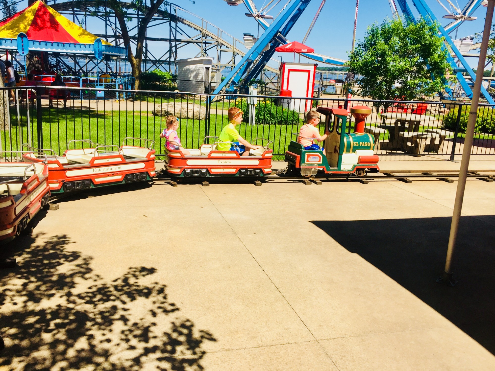 Children on a train ride at an amusement park.