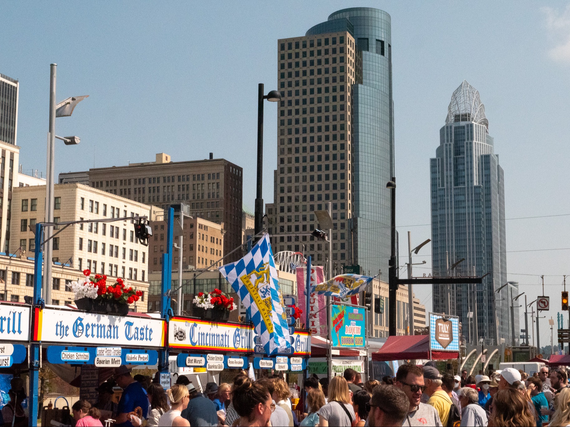 City buildings above a busy row of food stands