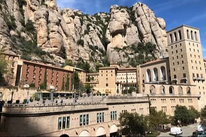 Montserrat, a mountain behind buildings in Spain.